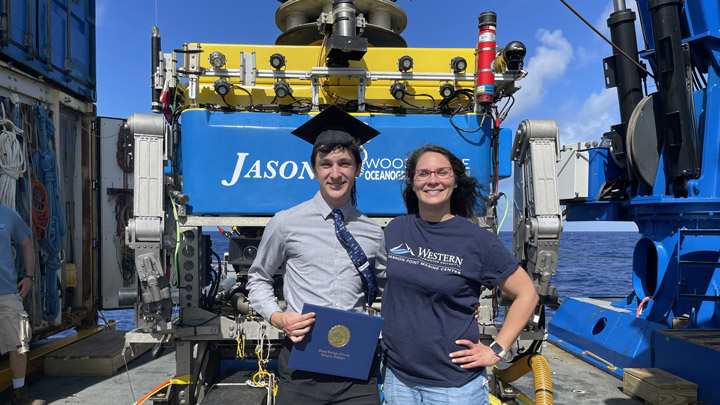 Dexter Davis (WWU, 2021) graduated with his B.S. in Environmental Science during our last research cruise on this project. Here he is with Shawn Arellano, his research advisor, right after ROV <em>Jason</em> presented him with his diploma.