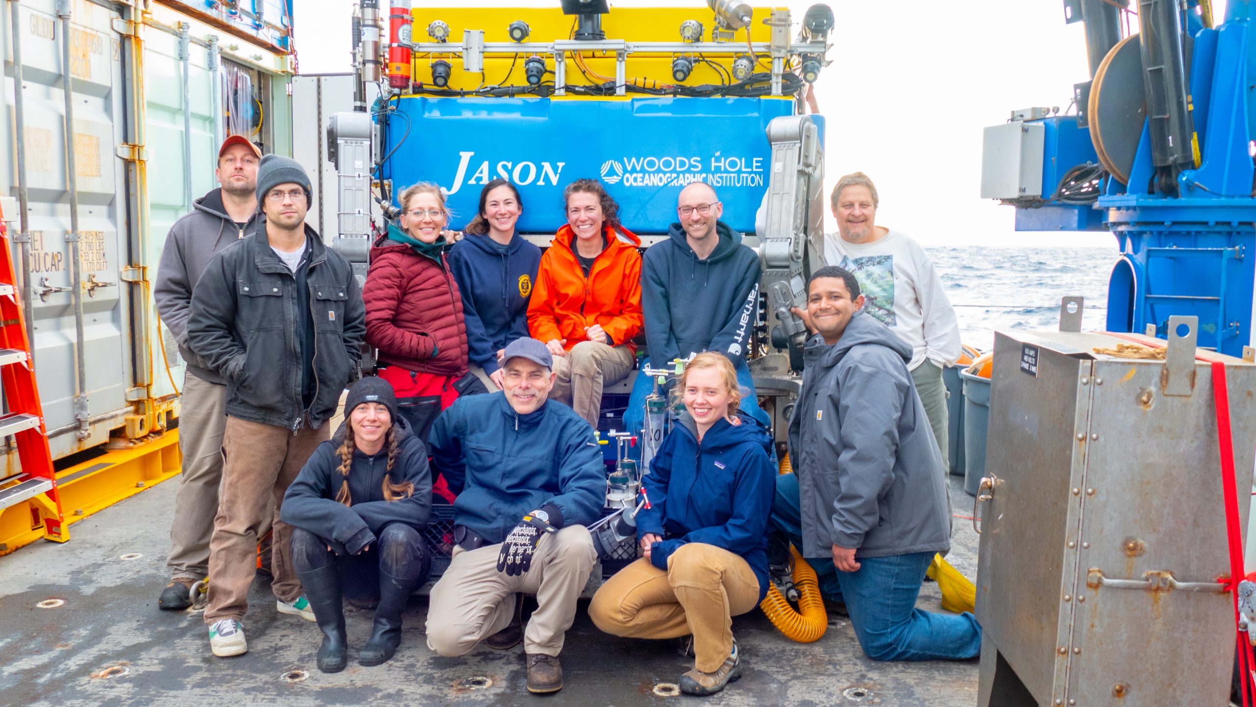 TheJason team standing near the ROV on the deck of ship.