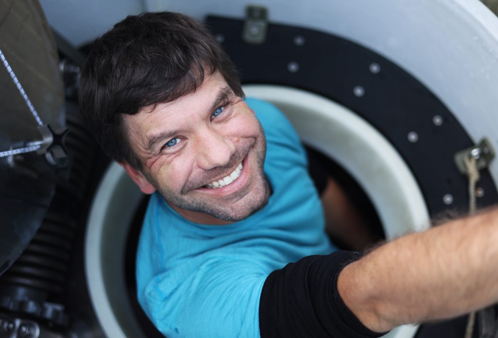 Andy Klesh smiles as he climbs out of Alvin after a successful dive on August 13, 2022. Photo by Marley Parker © Woods Hole Oceanographic Institution