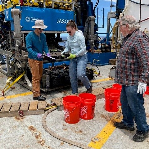 Sample recovery from dive J2-1563. Pictured are science party members, from left, Josh Pi and Rebecca Lipitt (URI), Dave Kuentz (Miami University), and Kenneth Montalvo (ACREUS participant).